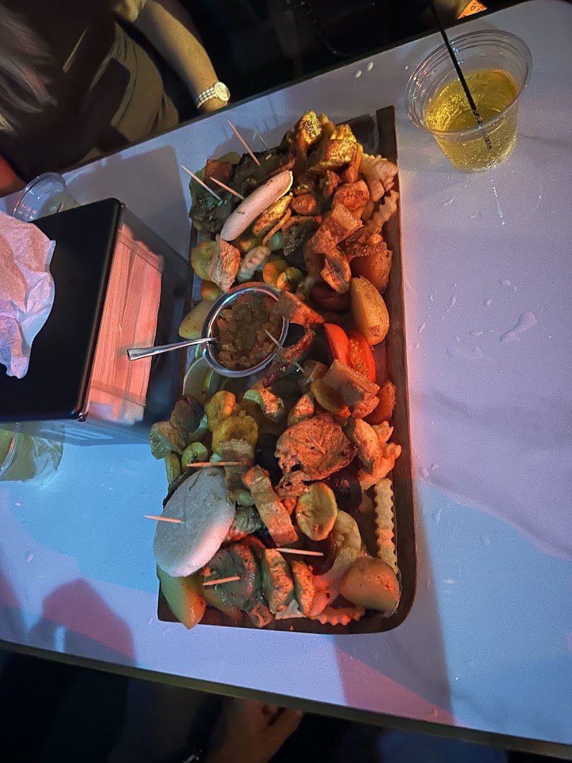 Comfort food setting with drinks and shared tables.