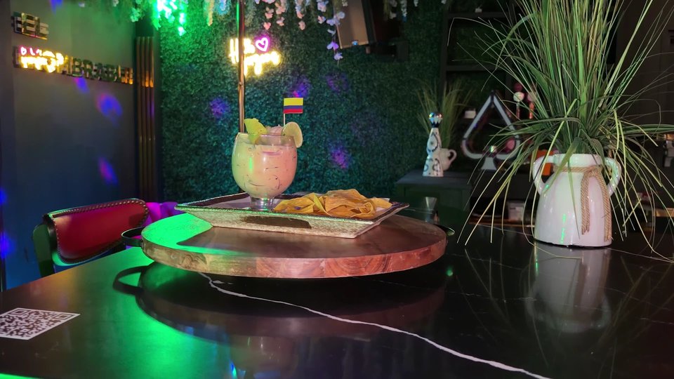Warm bar interior with tables and colorful decor.